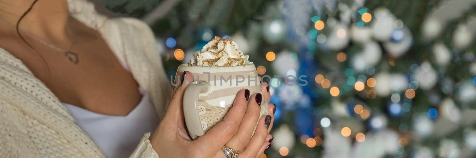 Morning coffee with whipped cream and marshmallows. Autumn composition. Hand with a cup. Composition with light cups and glass sugar bowl.