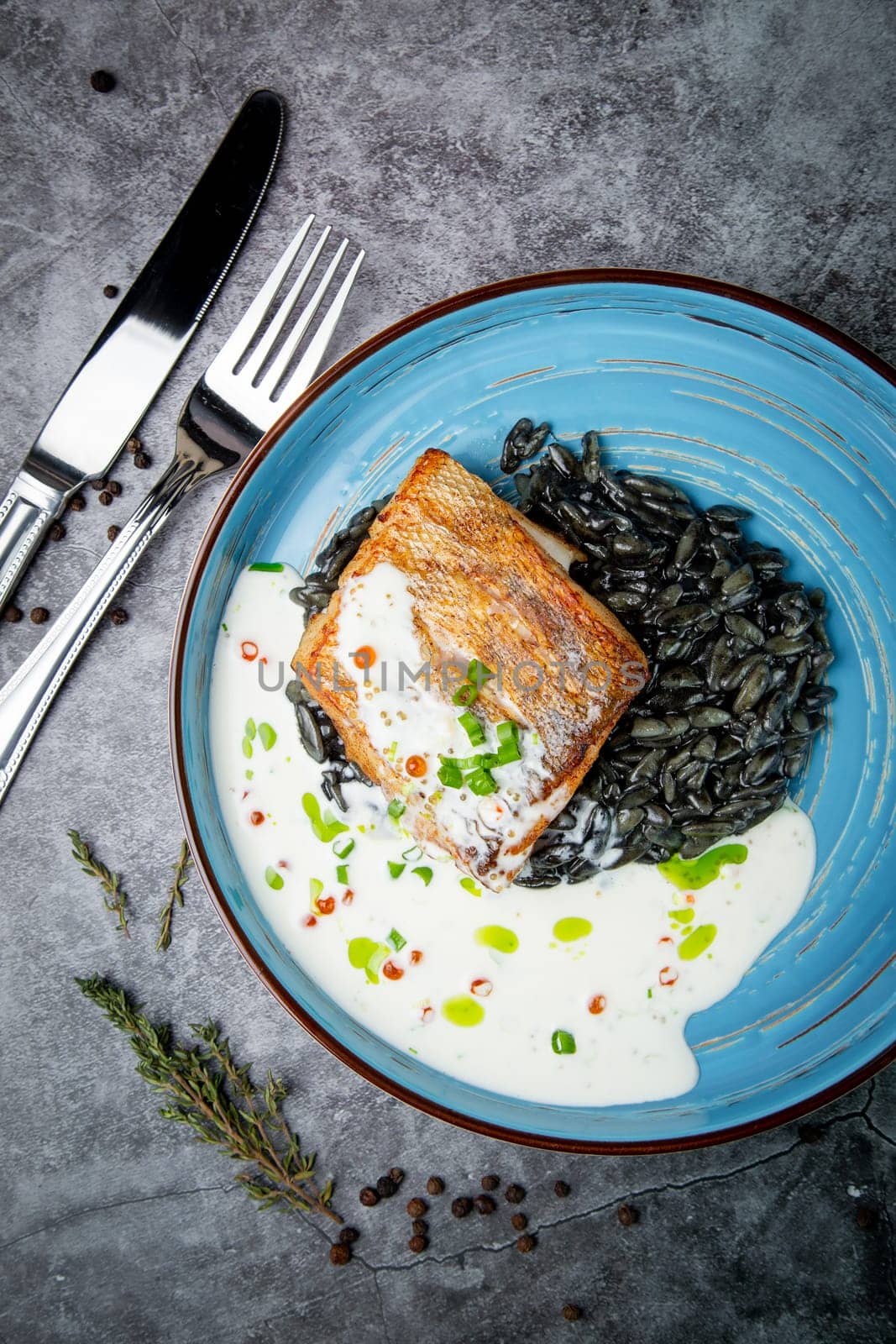 black beans with big fish steak, green onions and cream sauce