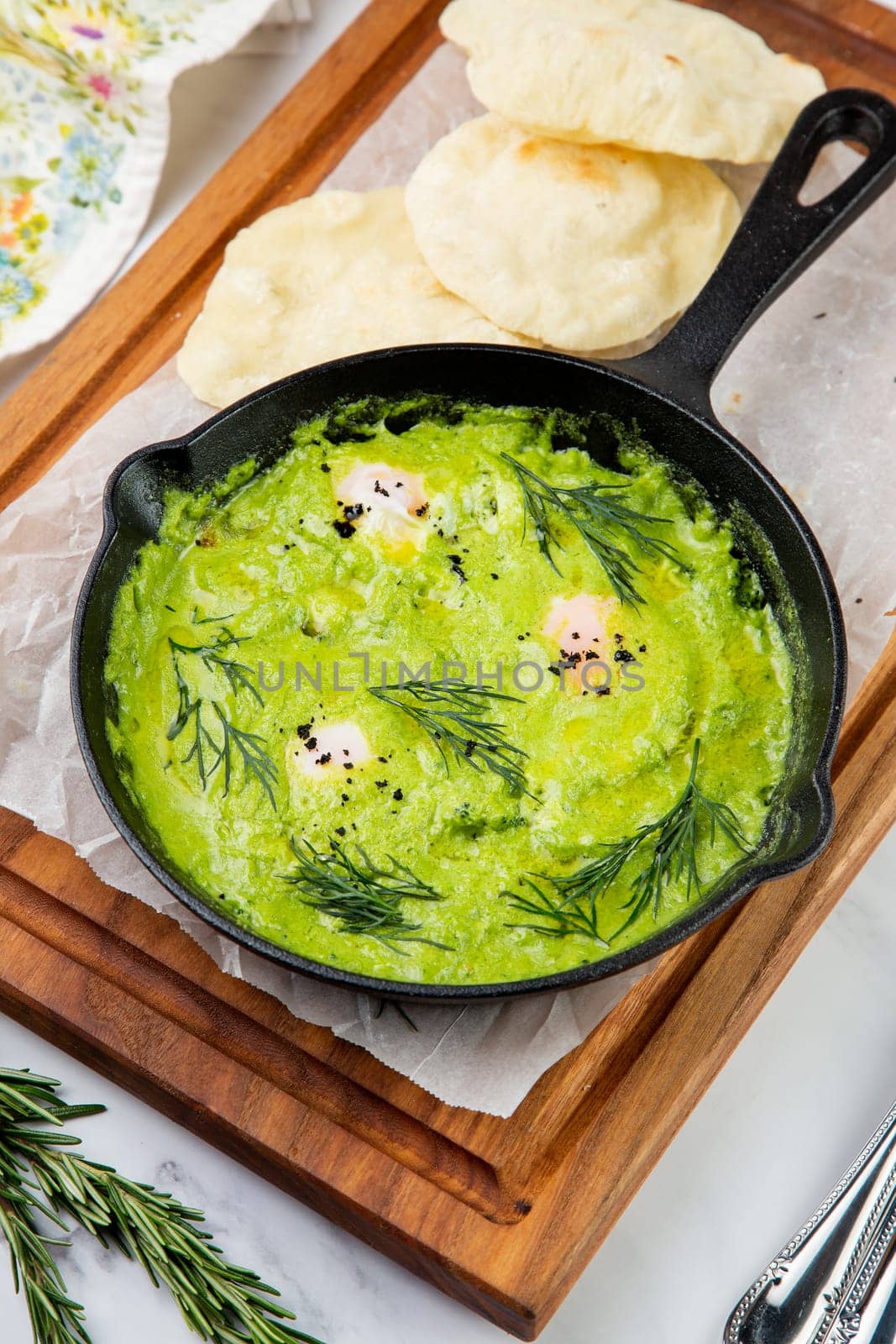 broccoli cream soup with herbs, cheese and tortillas in a frying pan
