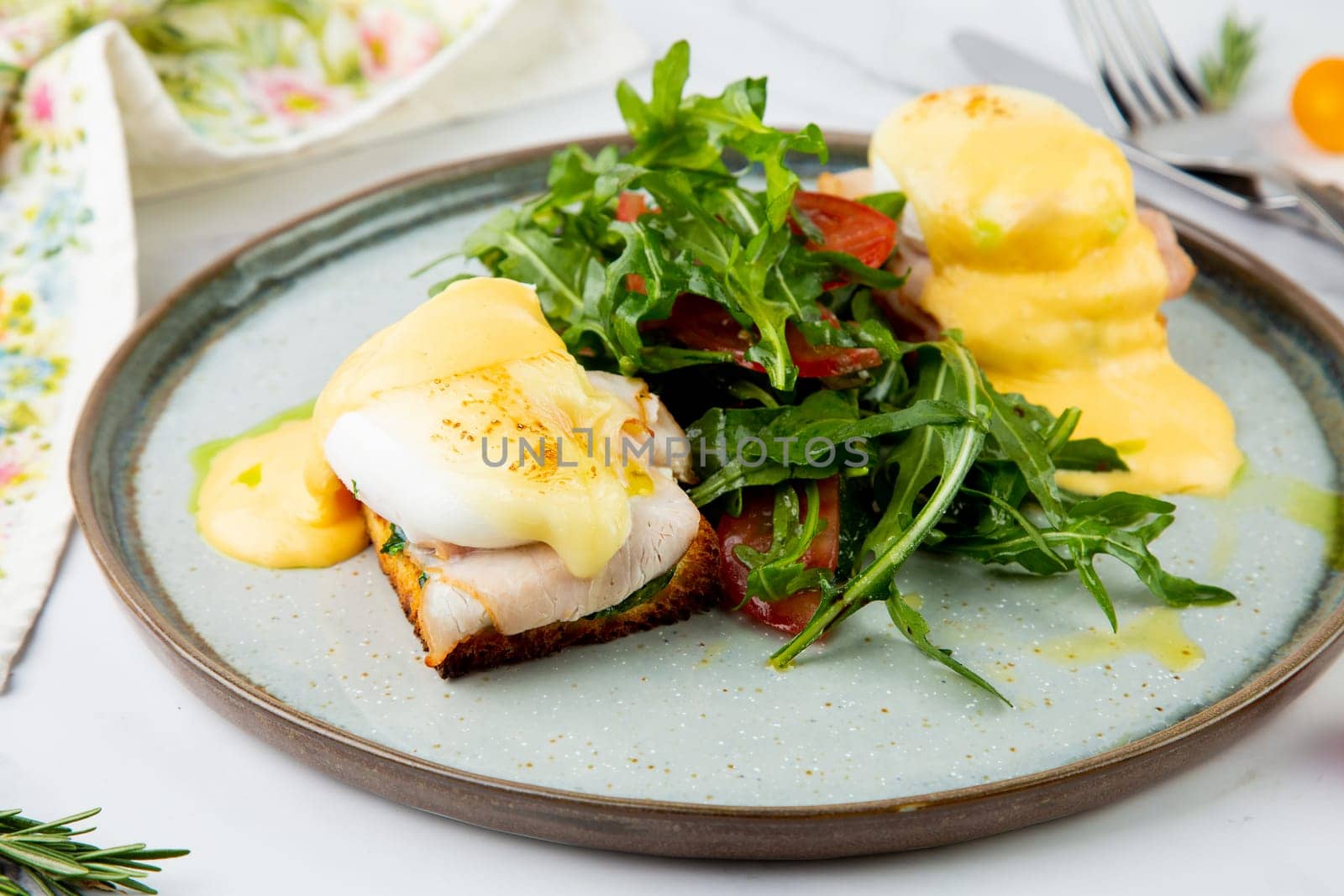 breakfast of arugula and tomato, toast with cheese and poached egg