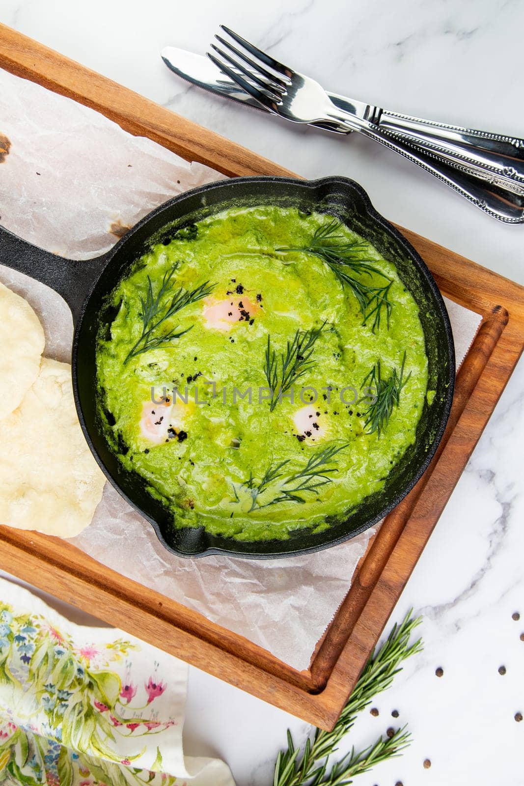 broccoli cream soup with herbs, cheese and tortillas in a frying pan