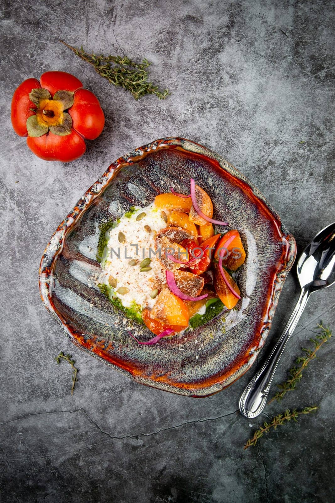 dish of baked persimmons, colored peppers, rice and seeds