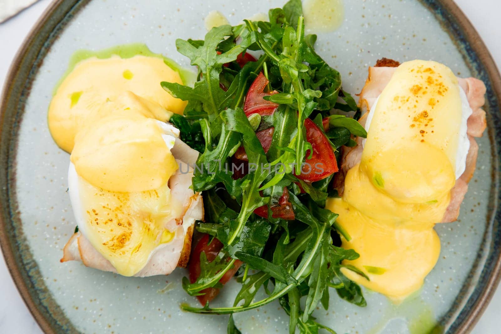 breakfast of arugula and tomato, toast with cheese and poached egg, top view by tewolf