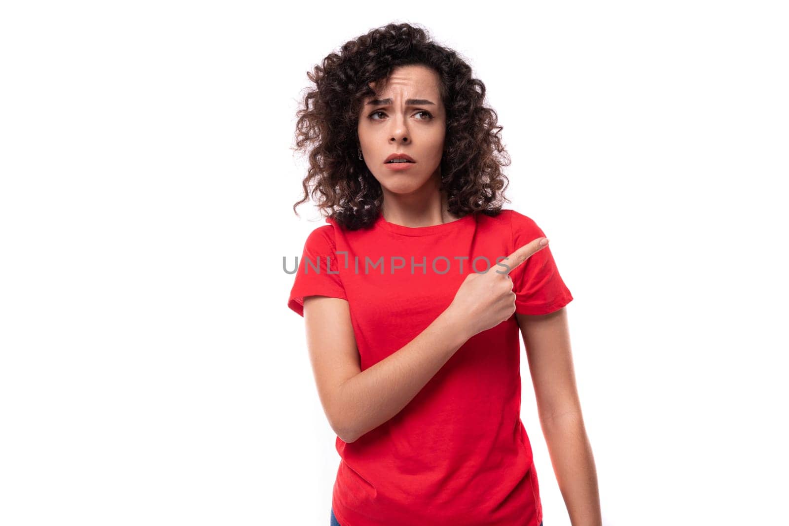 portrait of a 30 year old woman dressed in a red basic t-shirt on a white background with copy space.