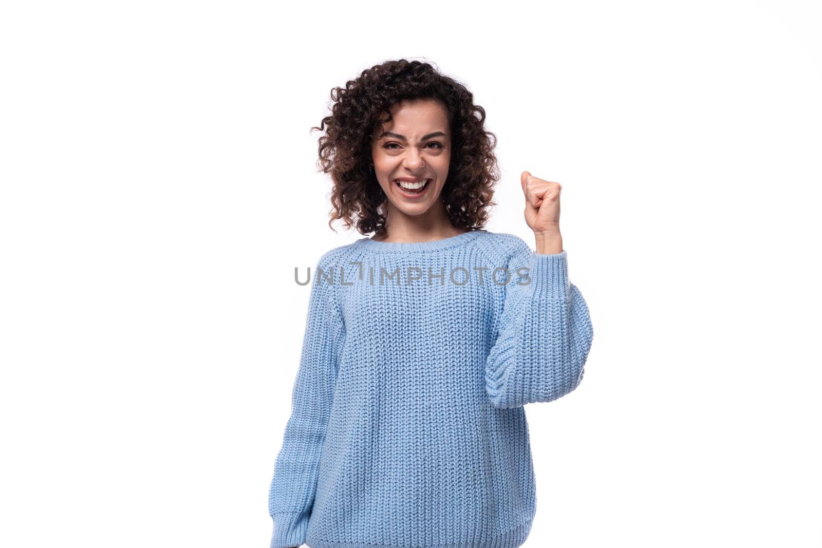 young pretty woman with curly method hairstyle smiling on background with copy space.