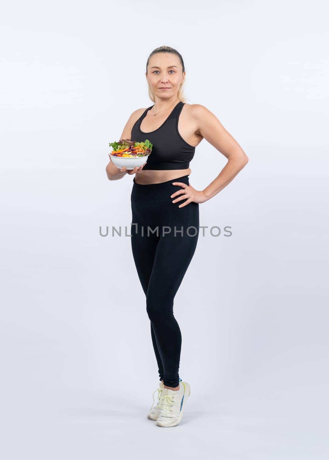 Happy smile senior woman portrait holding bowl of vegan fruit and vegetable on isolated background. Healthy senior people with healthy vegetarian nutrition and body care lifestyle. Clout