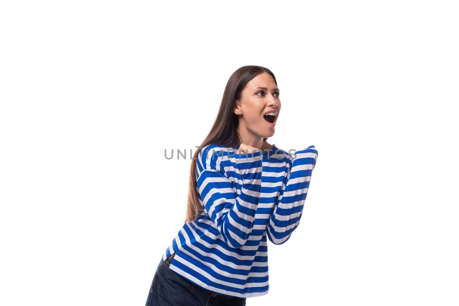 young cute slender brunette lady with straight hair is dressed in a blue striped sailor jacket.
