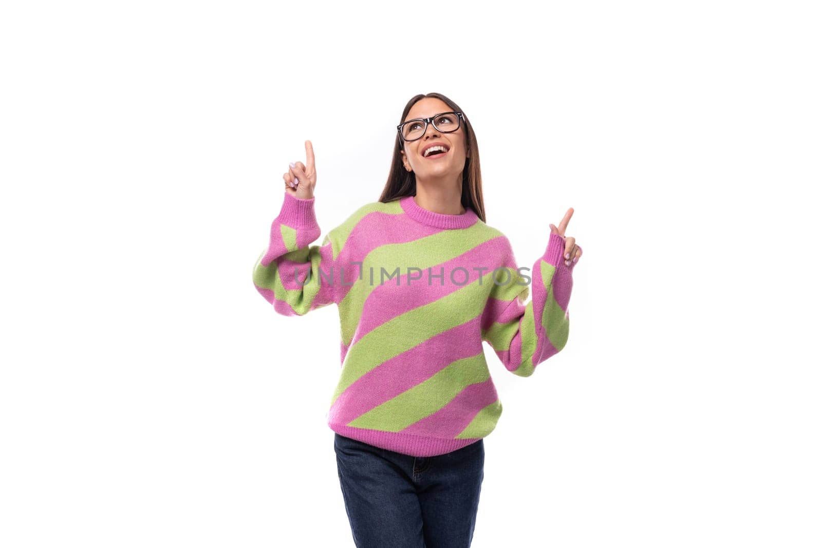 pretty dreamy 35 year old feminine model woman with glasses is dressed in a striped pink-green sweater on a white background.