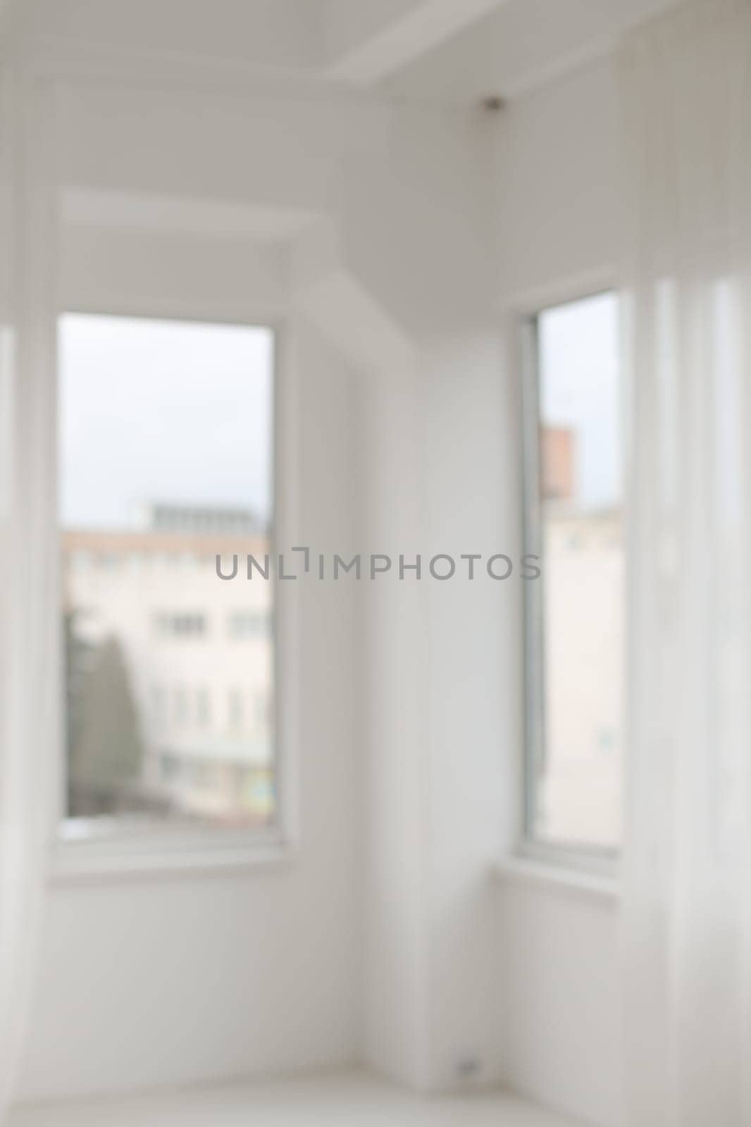 Abstract blurred modern workspace background, white indoor interior with window with copy space. Blurry backgrounds. Blurred view of light room with big window by paralisart