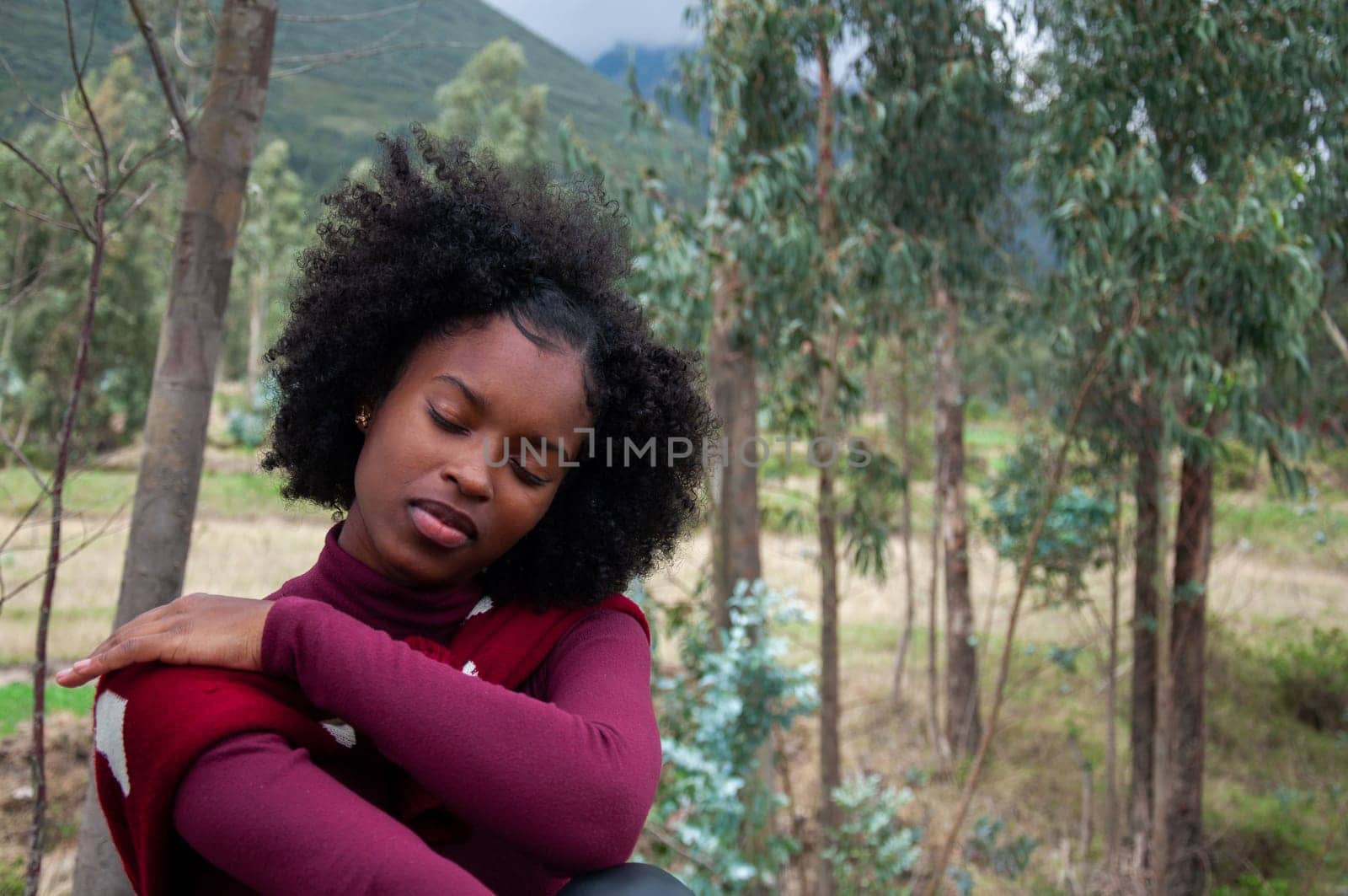 copy space of a young african american girl posing hugging herself with her eyes closed feeling the tranquility of nature. Earth day by Raulmartin