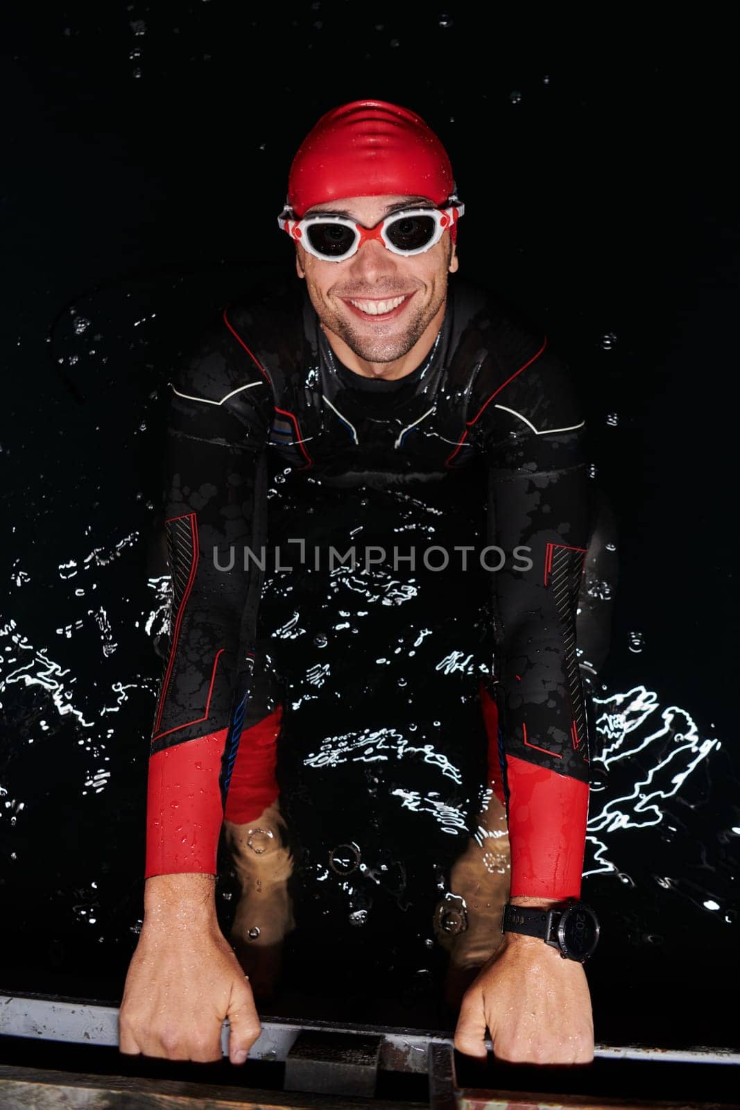 A determined professional triathlete undergoes rigorous night time training in cold waters, showcasing dedication and resilience in preparation for an upcoming triathlon swim competition by dotshock