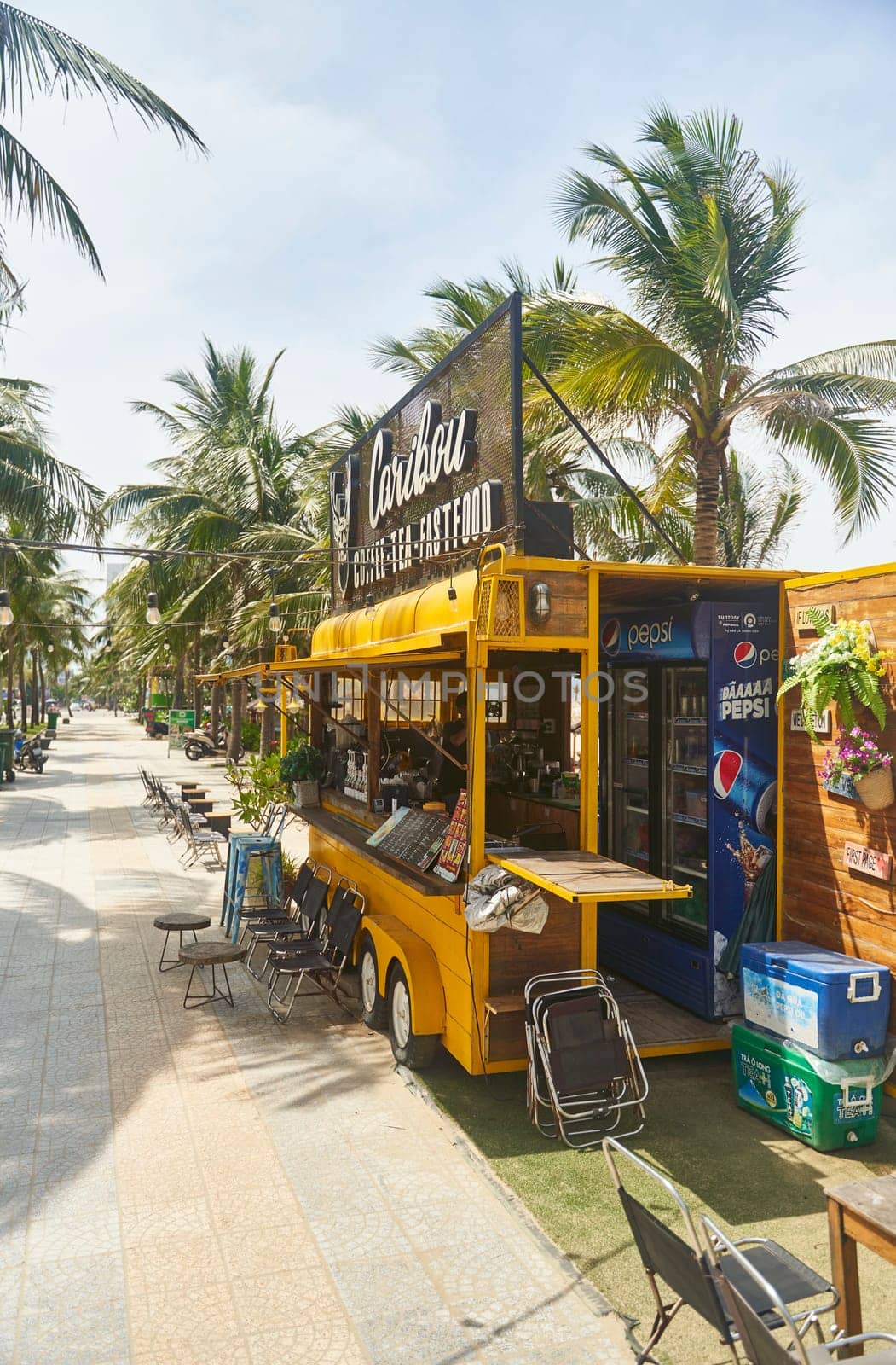 Da Nang, Viet nam - 28.06.2023: Promenade with palm trees and cafes on My Khe beach in Da Nang. High quality photo