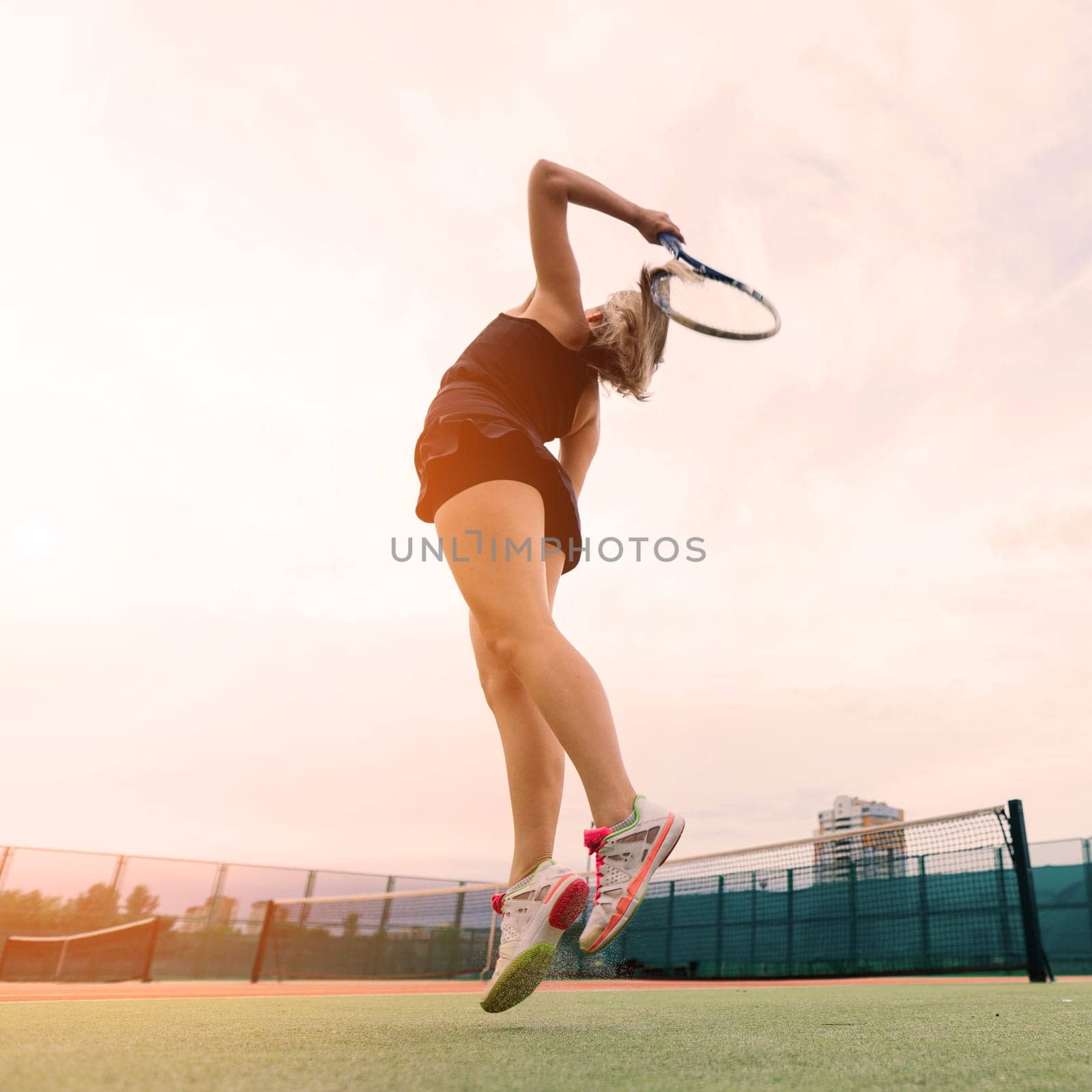 Tennis tournament. Female player at clay tennis court