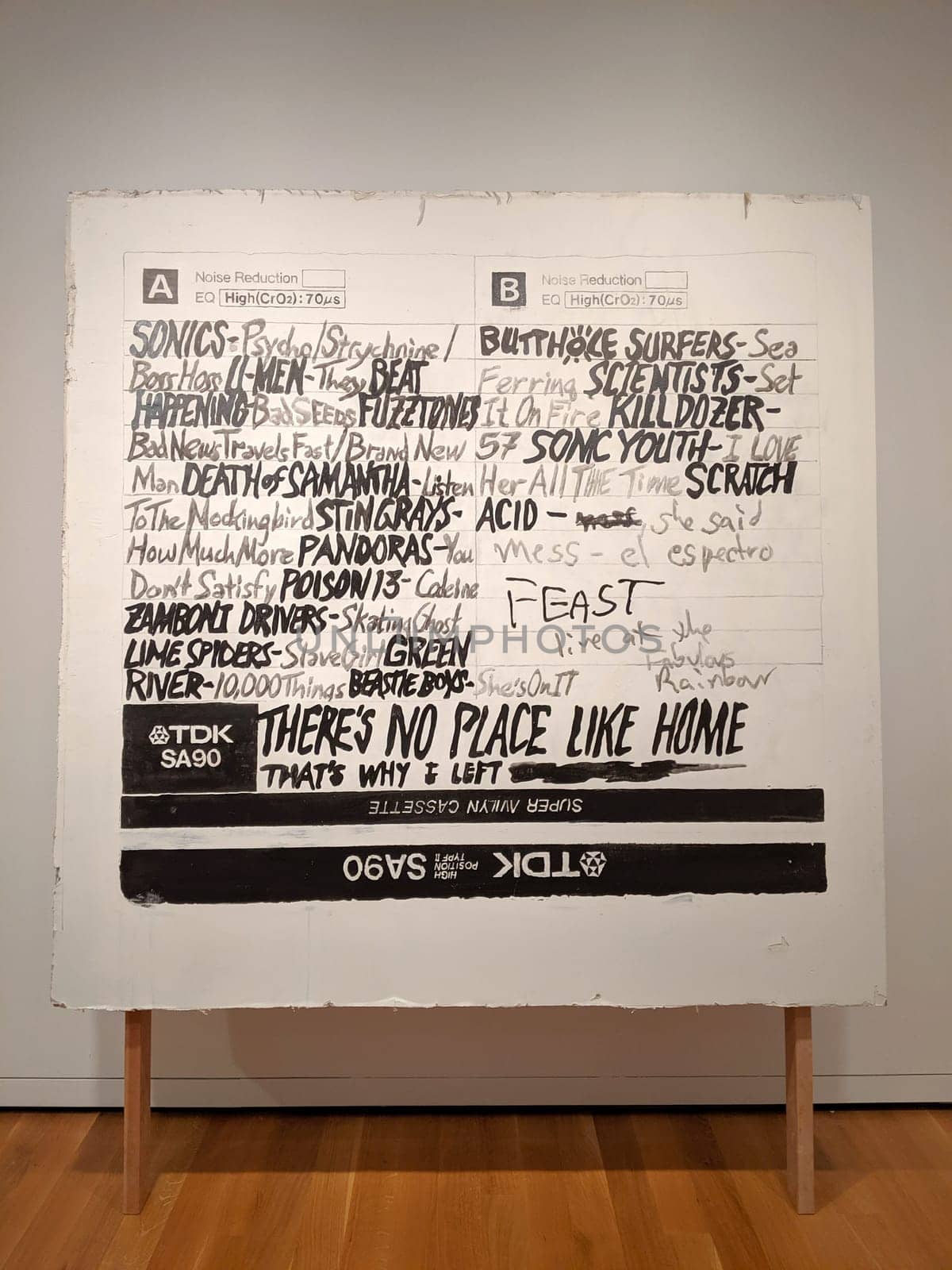 Seattle - May 16, 2019:  Mixtape label artwork displayed at the Seattle Art Museum. The artwork is a black and white label with handwritten text and drawings, featuring the name of bands Bestie Boys, Butthole Surfers and others. The label is torn on the edges and has a black border. The photo is taken from a close-up angle, showing the details and texture of the label.