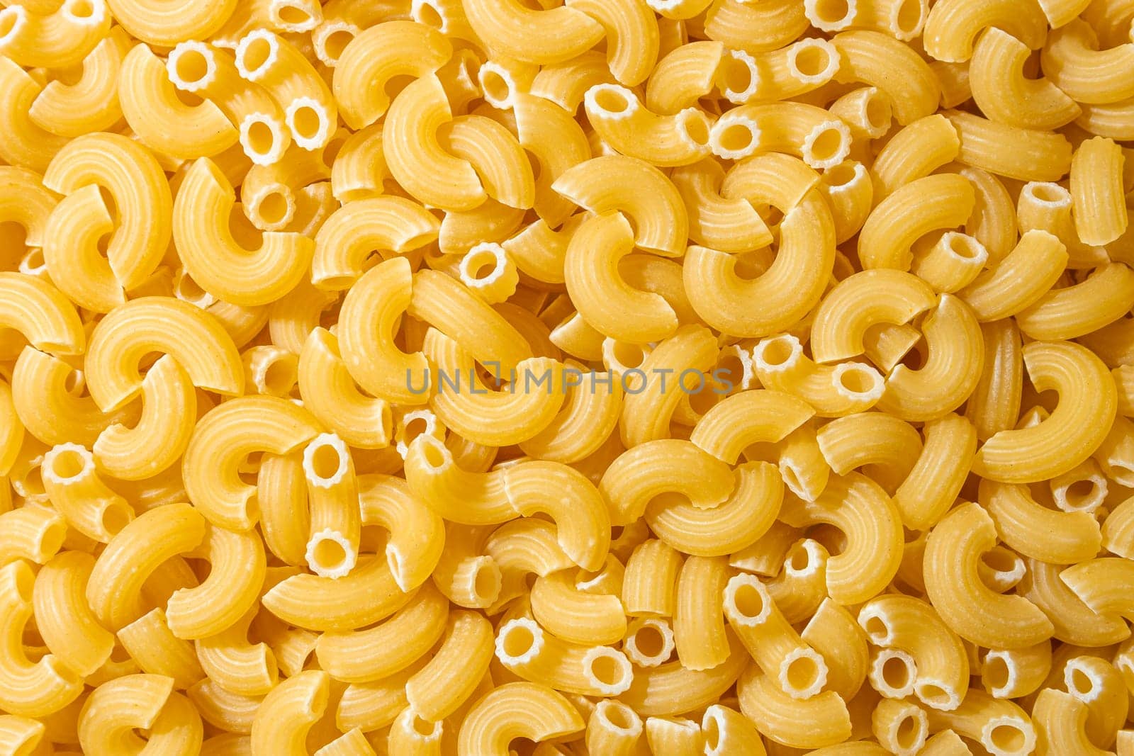 Uncooked Chifferi Rigati Pasta: A Culinary Canvas of Chifferi Rigati, Creating a Lively and Textured Background for Gourmet Cooking. Dry Pasta. Raw Macaroni - Top View, Flat Lay