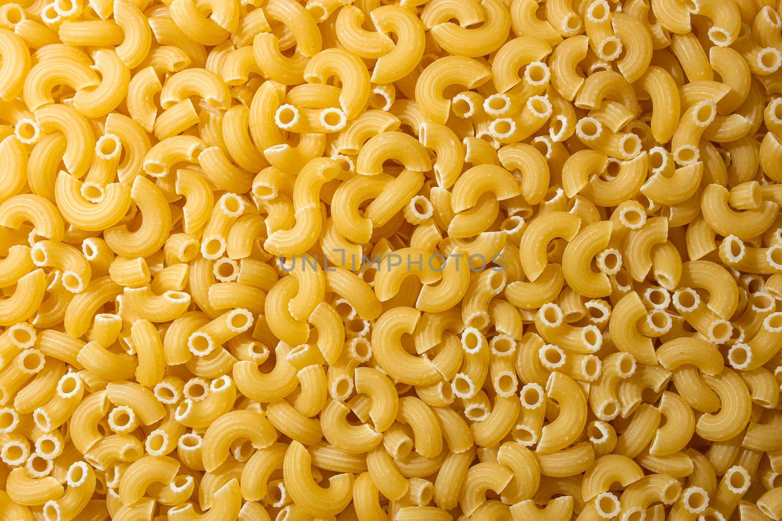 Uncooked Chifferi Rigati Pasta: A Culinary Canvas of Chifferi Rigati, Creating a Lively and Textured Background for Gourmet Cooking. Dry Pasta. Raw Macaroni - Top View, Flat Lay