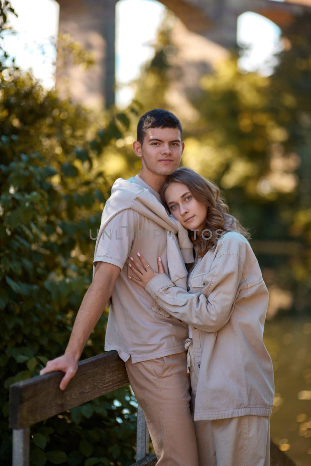 Young Cute Female Hugs Boyfriend. In Autumn Outdoor. Lovers Walking in Park. Attractive Funny Couple. Lovestory in Forest. Man and Woman. Cute Lovers in the Park. Family Concept. Happy Couple.