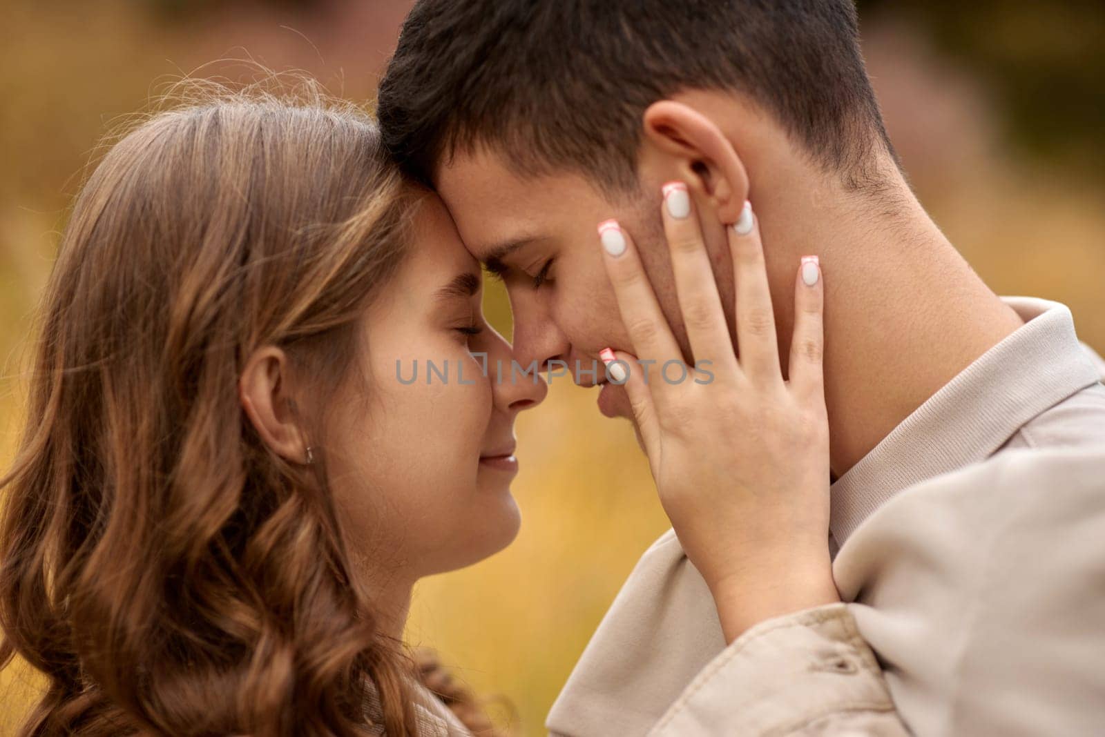 Young Cute Female Hugs Boyfriend. In Autumn Outdoor. Lovers Walking in Park. Attractive Funny Couple. Lovestory in Forest. Man and Woman. Cute Lovers in the Park. Family Concept. Happy Couple.