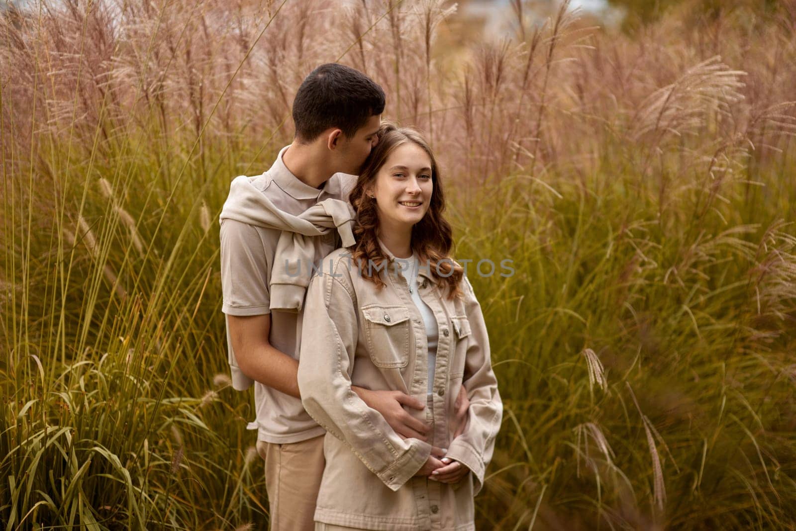 Young Cute Female Hugs Boyfriend. In Autumn Outdoor. Lovers Walking in Park. Attractive Funny Couple. Lovestory in Forest. Man and Woman. Cute Lovers in the Park. Family Concept. Happy Couple. by Andrii_Ko