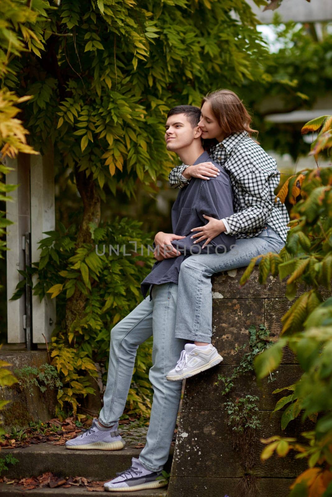 Young Cute Female Hugs Boyfriend. In Autumn Outdoor. Lovers Walking in Park. Attractive Funny Couple. Lovestory in Forest. Man and Woman. Cute Lovers in the Park. Family Concept. Happy Couple. by Andrii_Ko