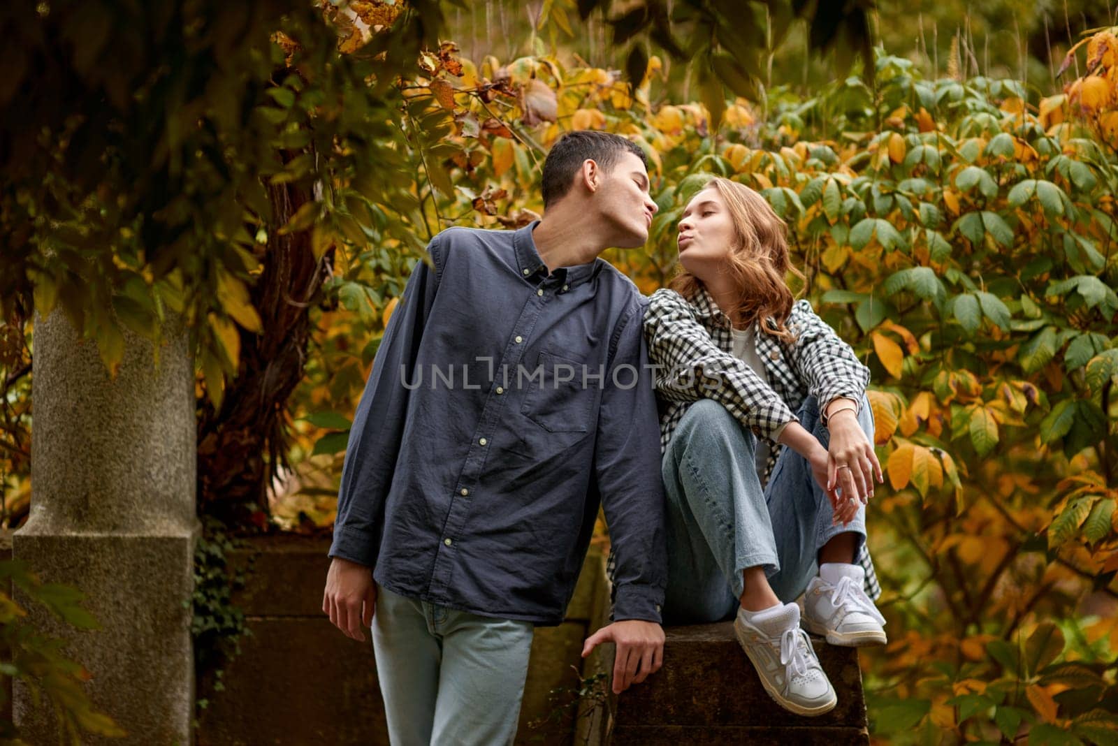 Young Cute Female Hugs Boyfriend. In Autumn Outdoor. Lovers Walking in Park. Attractive Funny Couple. Lovestory in Forest. Man and Woman. Cute Lovers in the Park. Family Concept. Happy Couple.