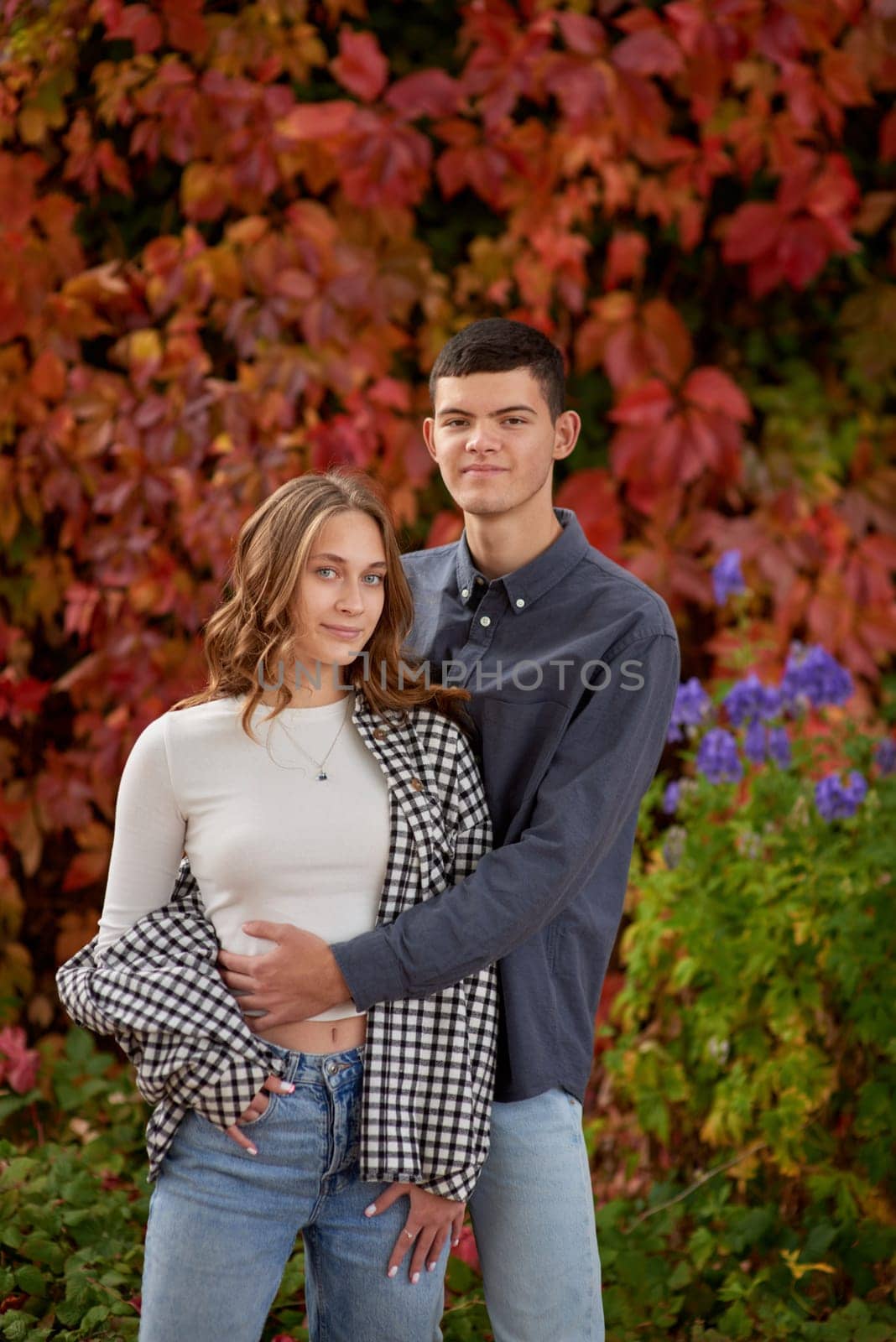 Young Cute Female Hugs Boyfriend. In Autumn Outdoor. Lovers Walking in Park. Attractive Funny Couple. Lovestory in Forest. Man and Woman. Cute Lovers in the Park. Family Concept. Happy Couple.