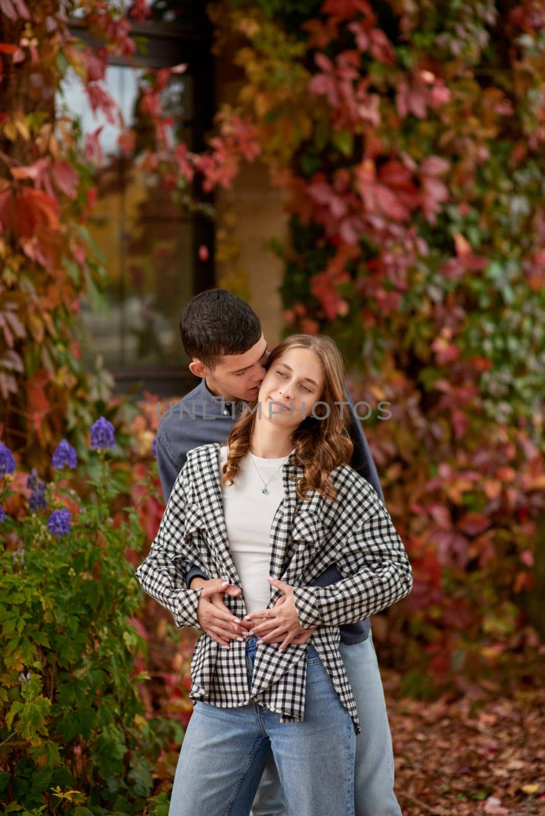 Young Cute Female Hugs Boyfriend. In Autumn Outdoor. Lovers Walking in Park. Attractive Funny Couple. Lovestory in Forest. Man and Woman. Cute Lovers in the Park. Family Concept. Happy Couple.