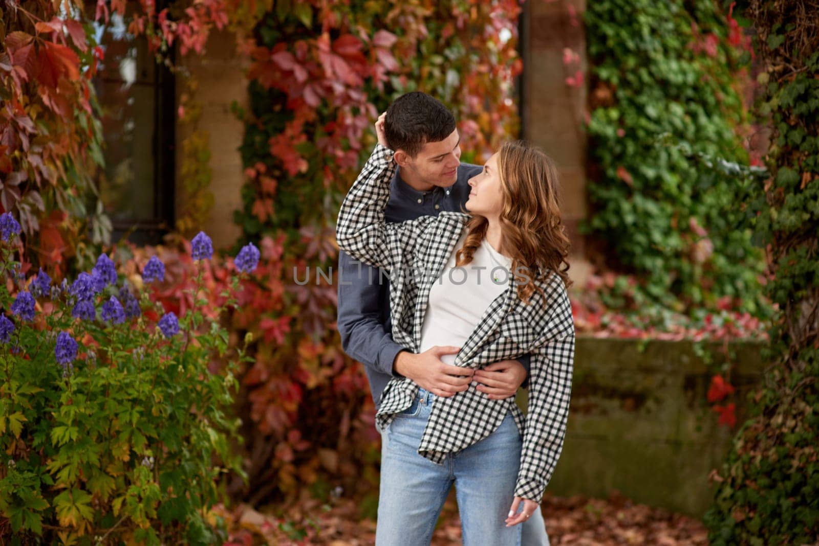 Young Cute Female Hugs Boyfriend. In Autumn Outdoor. Lovers Walking in Park. Attractive Funny Couple. Lovestory in Forest. Man and Woman. Cute Lovers in the Park. Family Concept. Happy Couple.