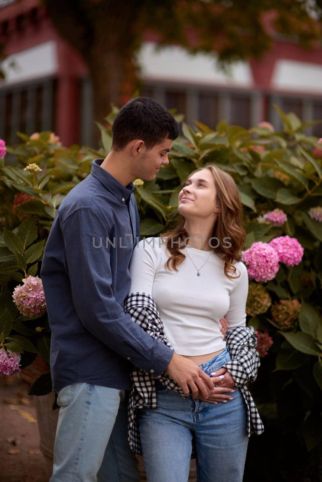 Young Cute Female Hugs Boyfriend. In Autumn Outdoor. Lovers Walking in Park. Attractive Funny Couple. Lovestory in Forest. Man and Woman. Cute Lovers in the Park. Family Concept. Happy Couple. by Andrii_Ko