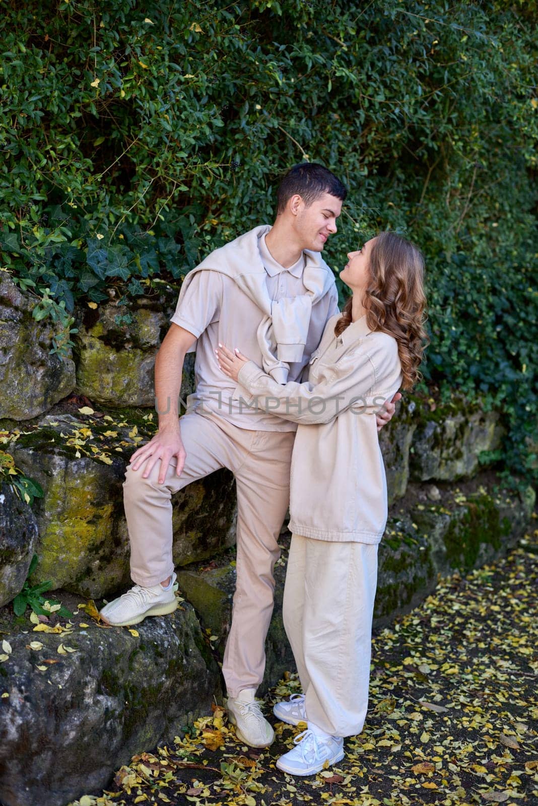 Young Cute Female Hugs Boyfriend. In Autumn Outdoor. Lovers Walking in Park. Attractive Funny Couple. Lovestory in Forest. Man and Woman. Cute Lovers in the Park. Family Concept. Happy Couple.