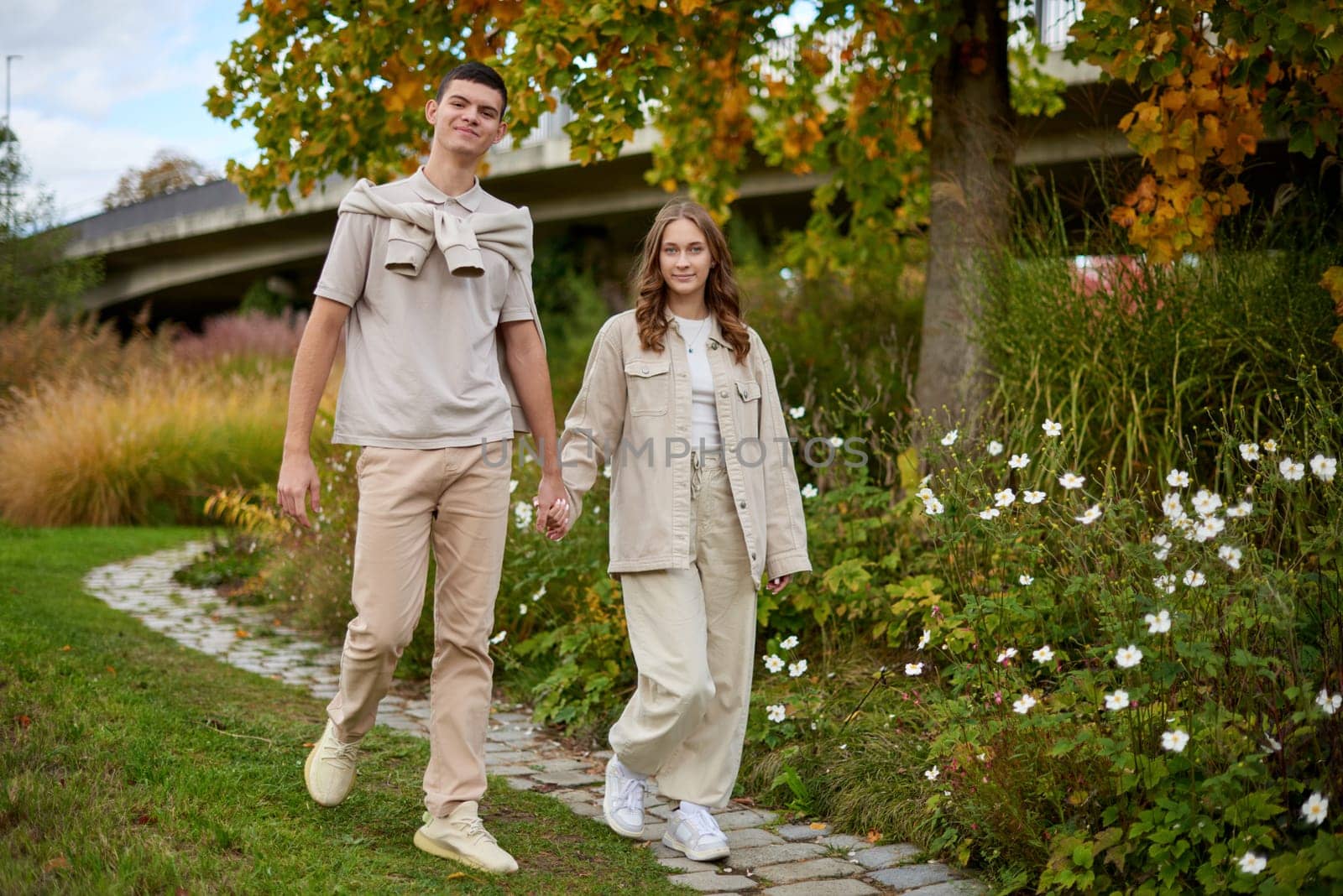 Young Cute Female Hugs Boyfriend. In Autumn Outdoor. Lovers Walking in Park. Attractive Funny Couple. Lovestory in Forest. Man and Woman. Cute Lovers in the Park. Family Concept. Happy Couple. by Andrii_Ko