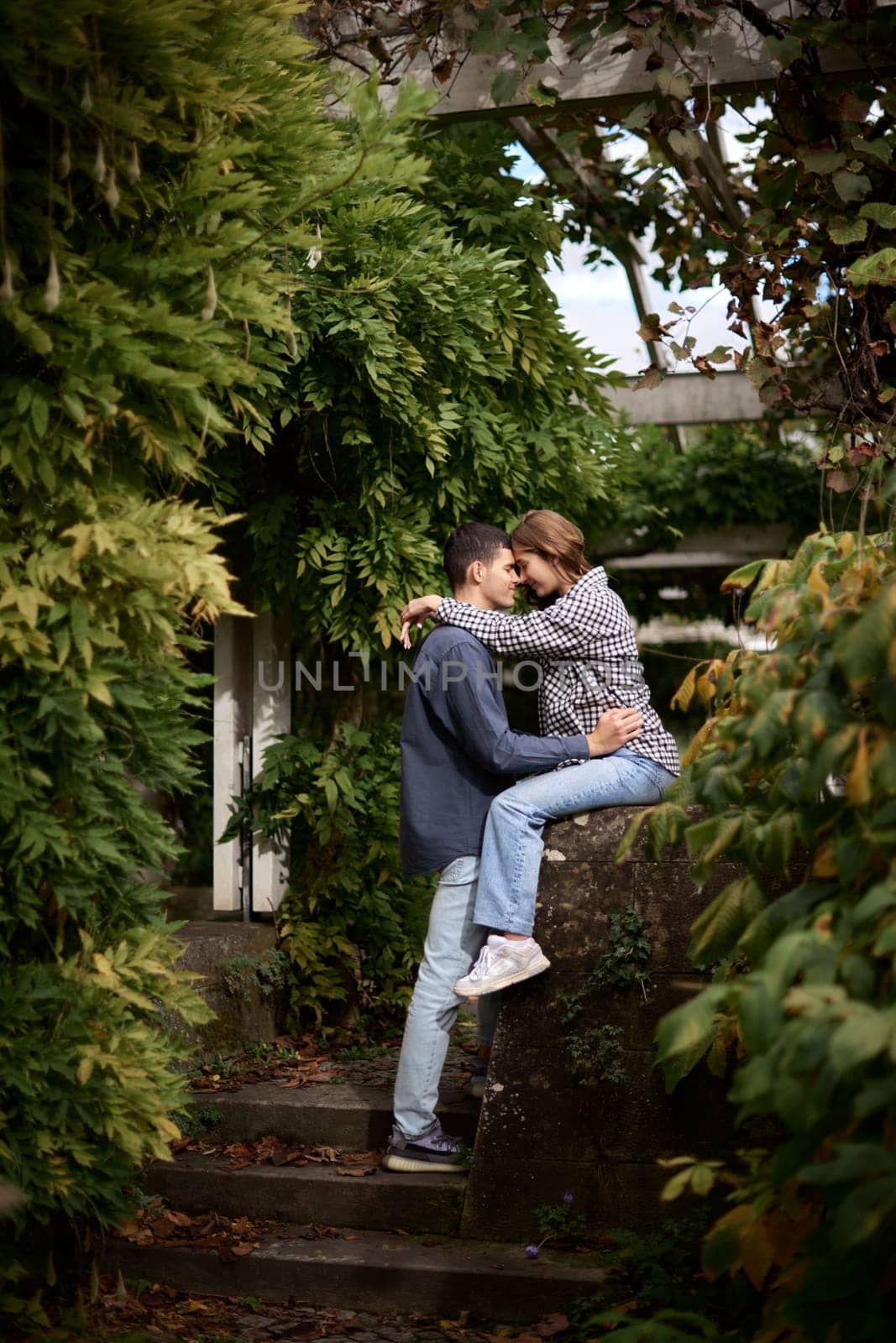 Young Cute Female Hugs Boyfriend. In Autumn Outdoor. Lovers Walking in Park. Attractive Funny Couple. Lovestory in Forest. Man and Woman. Cute Lovers in the Park. Family Concept. Happy Couple. by Andrii_Ko