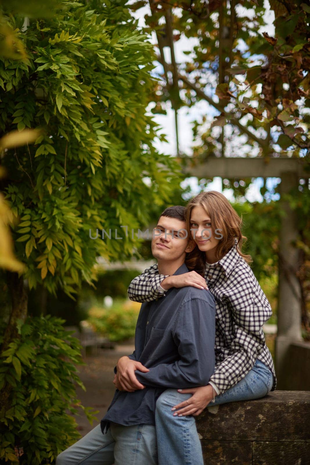 Young Cute Female Hugs Boyfriend. In Autumn Outdoor. Lovers Walking in Park. Attractive Funny Couple. Lovestory in Forest. Man and Woman. Cute Lovers in the Park. Family Concept. Happy Couple.