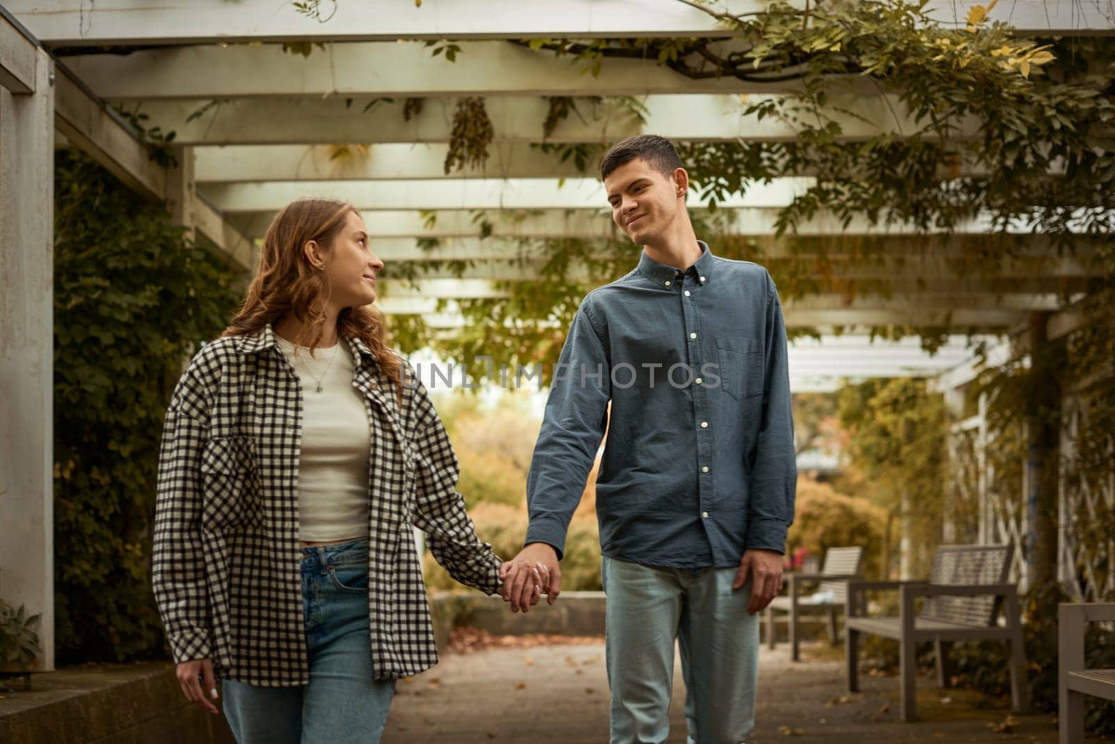 Young Cute Female Hugs Boyfriend. In Autumn Outdoor. Lovers Walking in Park. Attractive Funny Couple. Lovestory in Forest. Man and Woman. Cute Lovers in the Park. Family Concept. Happy Couple. by Andrii_Ko