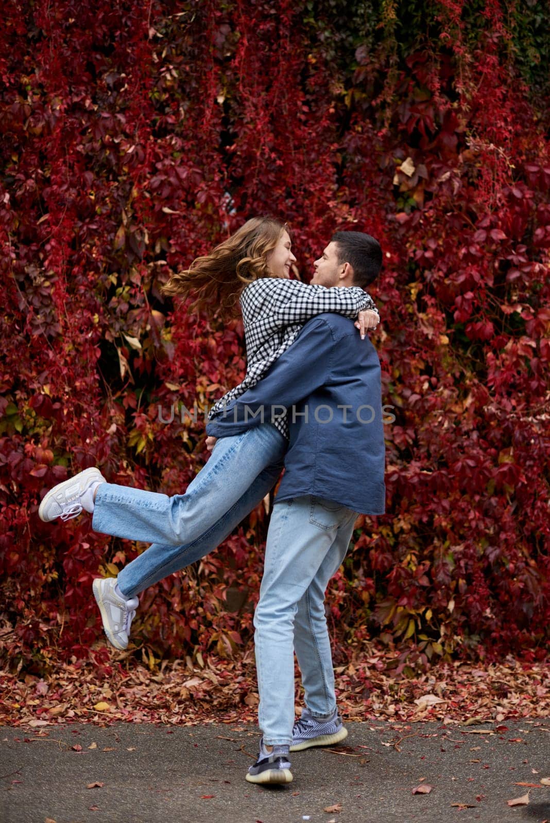 Young Cute Female Hugs Boyfriend. In Autumn Outdoor. Lovers Walking in Park. Attractive Funny Couple. Lovestory in Forest. Man and Woman. Cute Lovers in the Park. Family Concept. Happy Couple. by Andrii_Ko