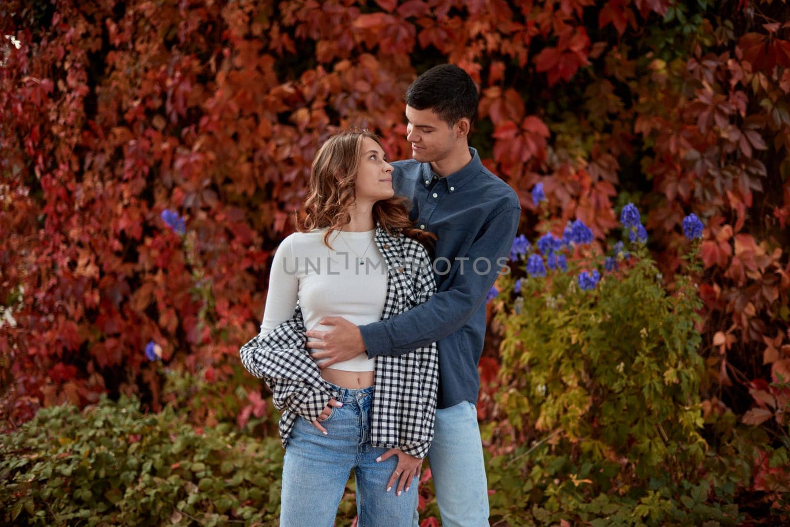 Young Cute Female Hugs Boyfriend. In Autumn Outdoor. Lovers Walking in Park. Attractive Funny Couple. Lovestory in Forest. Man and Woman. Cute Lovers in the Park. Family Concept. Happy Couple.