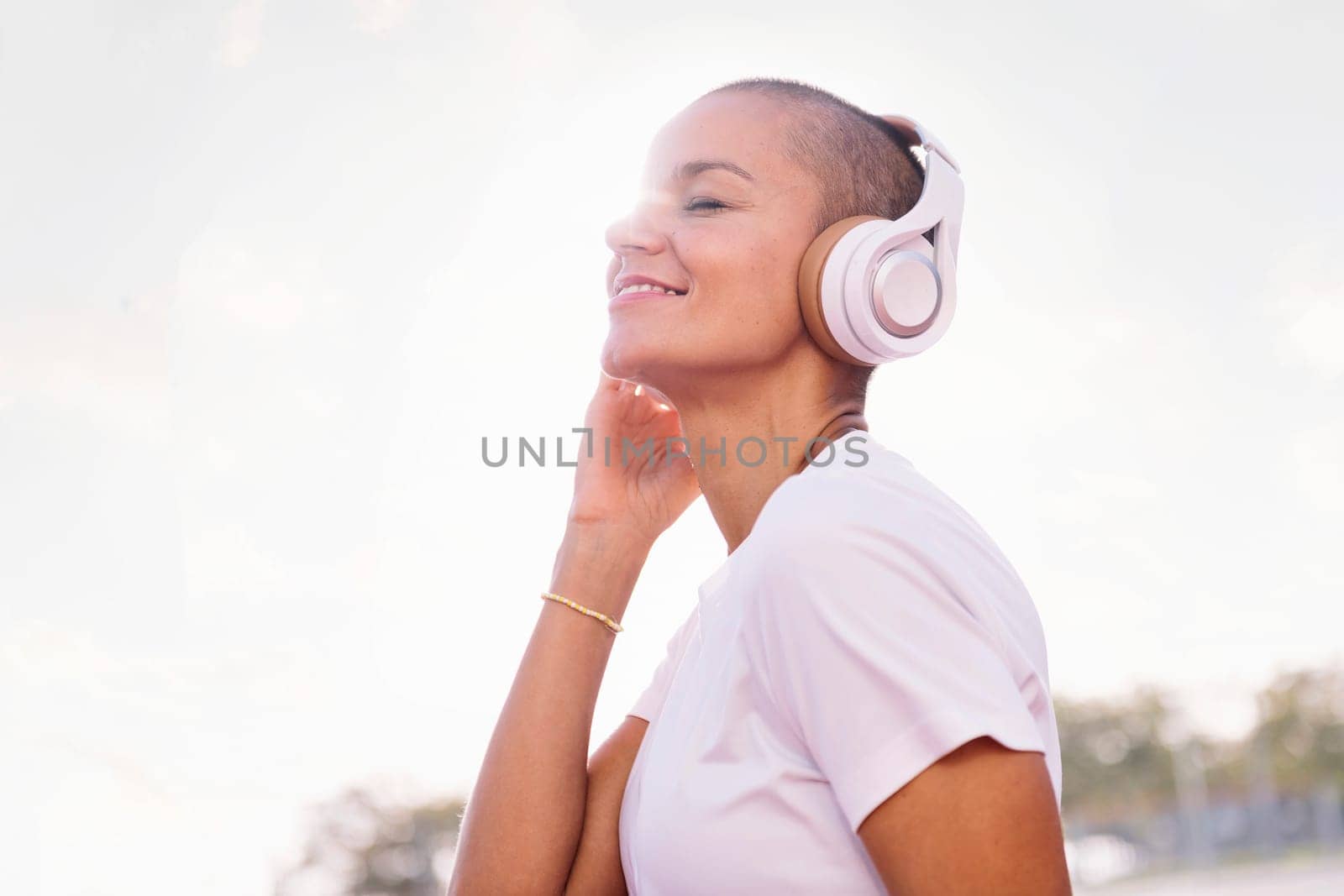 young woman smiling happy and listening to music in her headphones, concept of rhythm and happiness, copy space for text