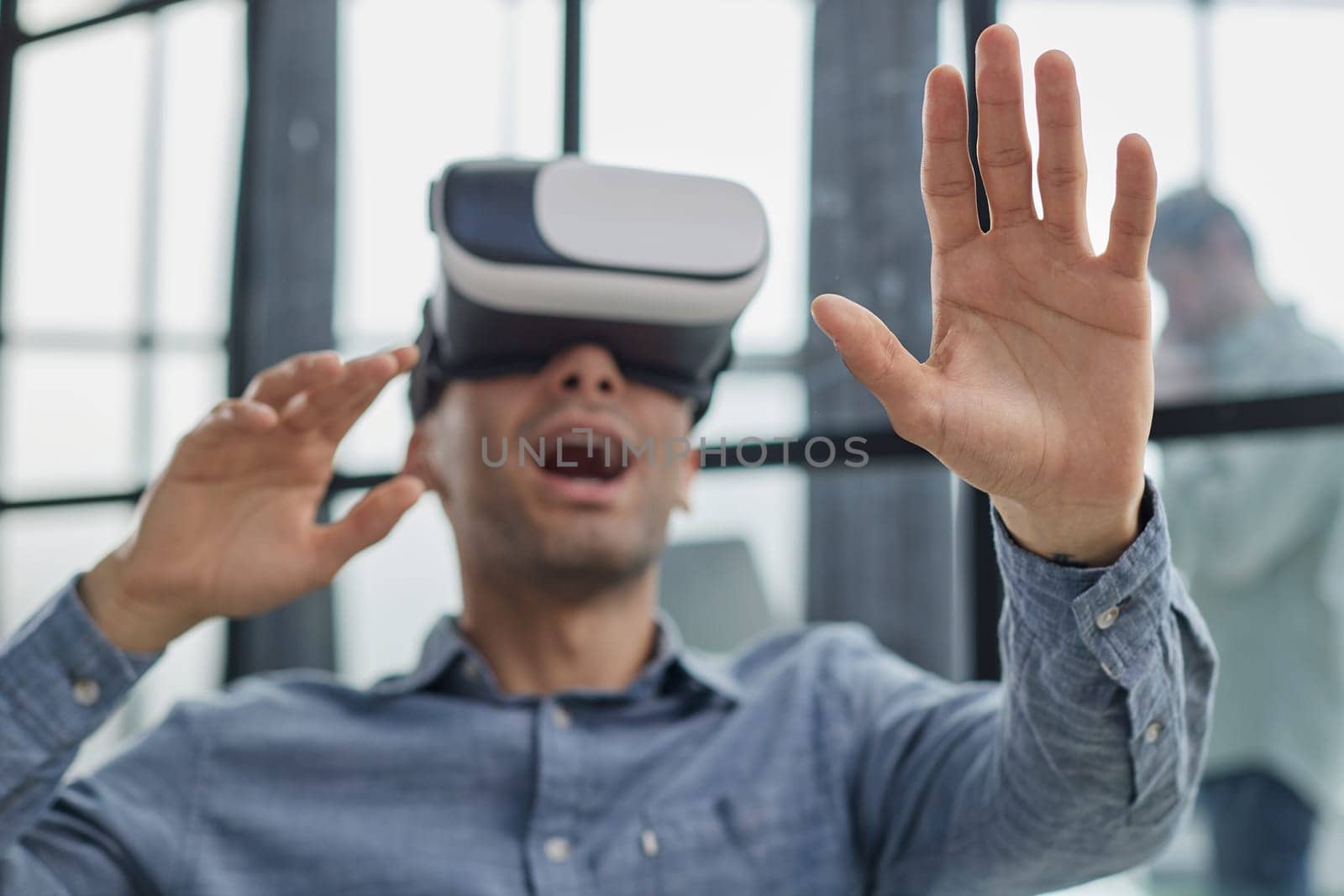 smiling young man using virtual reality headset while sitting in office Generative AI