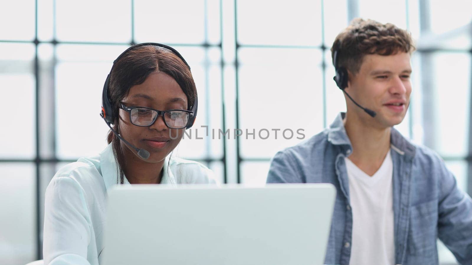 operators woman and man agent with headsets working in a call center.