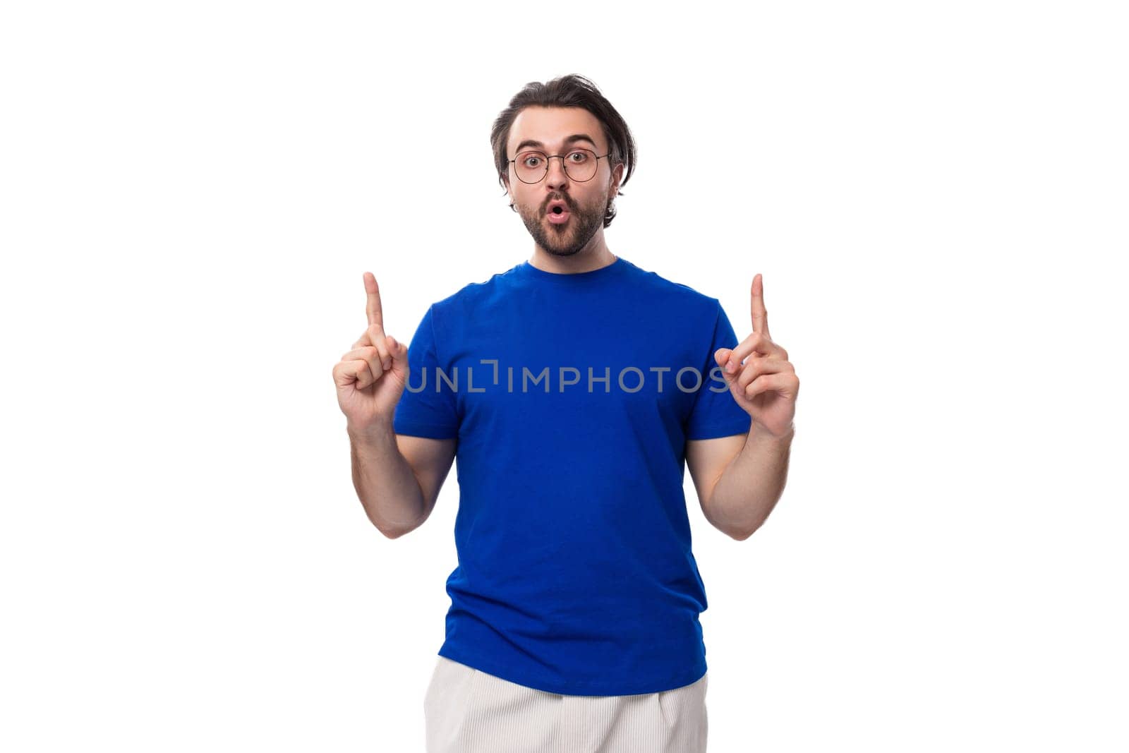 young well-groomed brunette man with a beard in a t-shirt with a brand mockup by TRMK