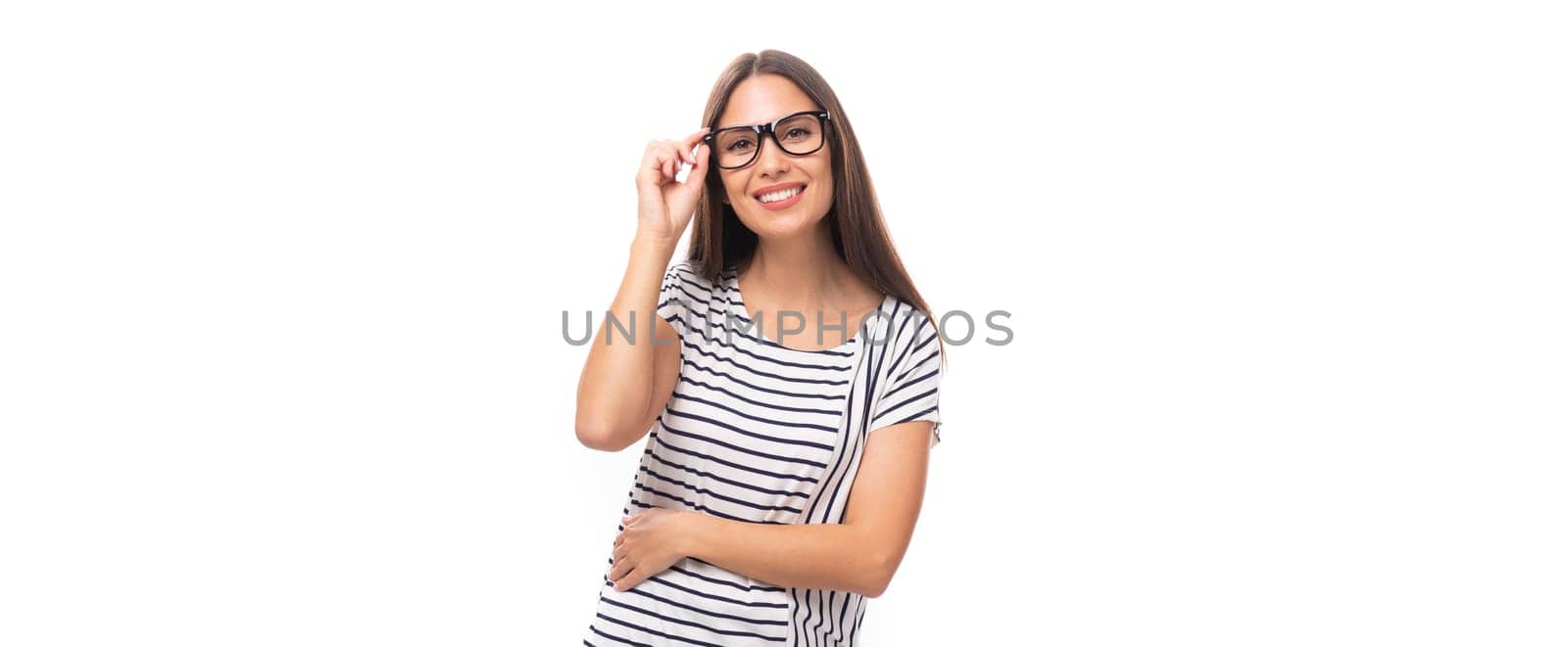 young well-groomed pleasant Caucasian brunette woman in a striped t-shirt posing on a white one with copy space by TRMK