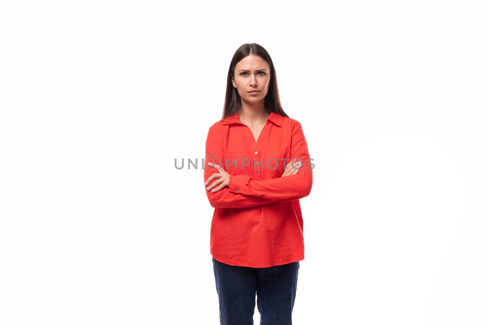 young pretty brunette office worker woman dressed in a red loose shirt on a white background.