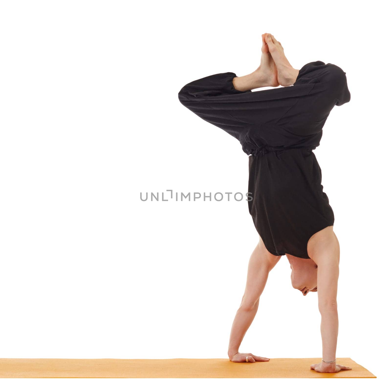 Yoga lessons. Instructor doing handstand, isolated on white