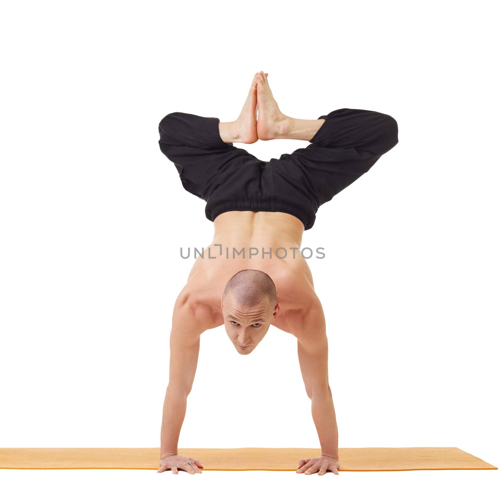 Yogi looking at camera while doing handstand by rivertime