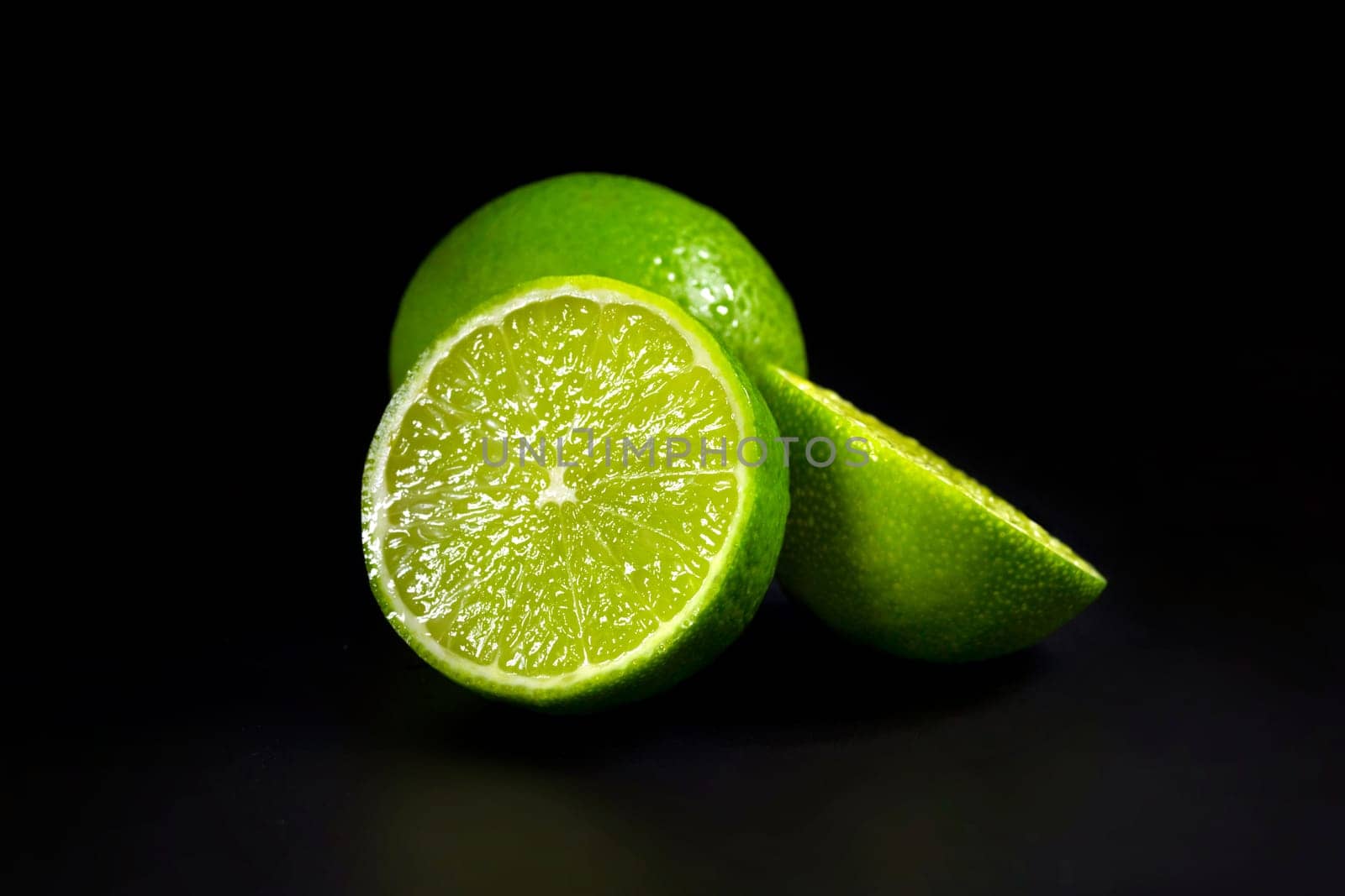 Fresh lime on a dark background, close up. Tropical citrus fruits.