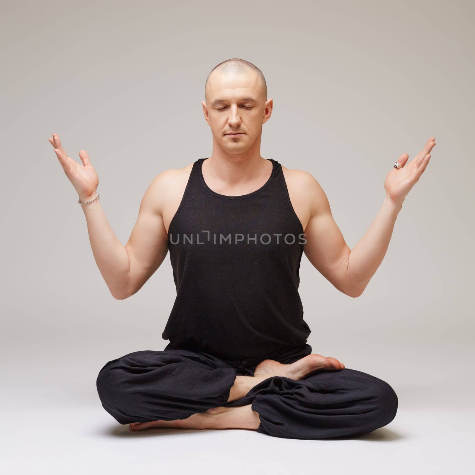 Studio photo of yoga instructor meditating by rivertime