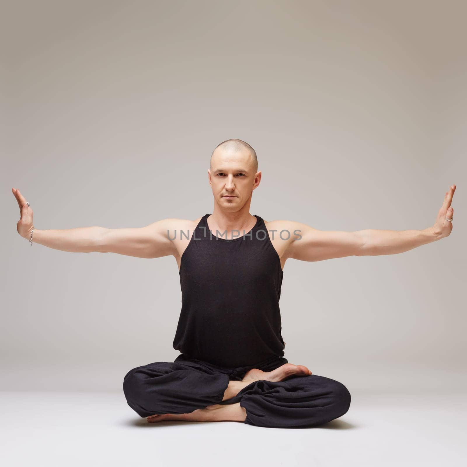 Attractive yoga master posing at camera while exercising