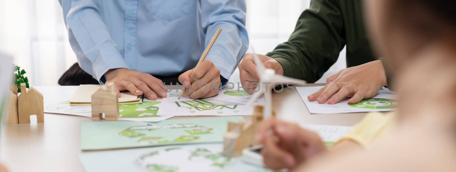 Green business meeting represented renewable energy. Skilled businesspeople discuss green business investment at table with environmental documents. Closeup. Focus on hand. Delineation.
