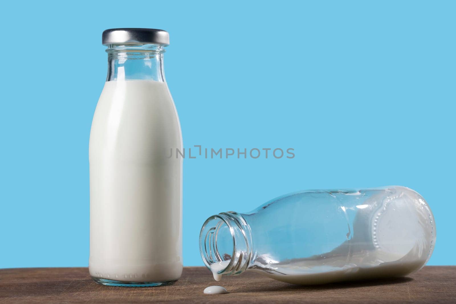Bottle of milk on a blue background. Close-up. Healthy food.
