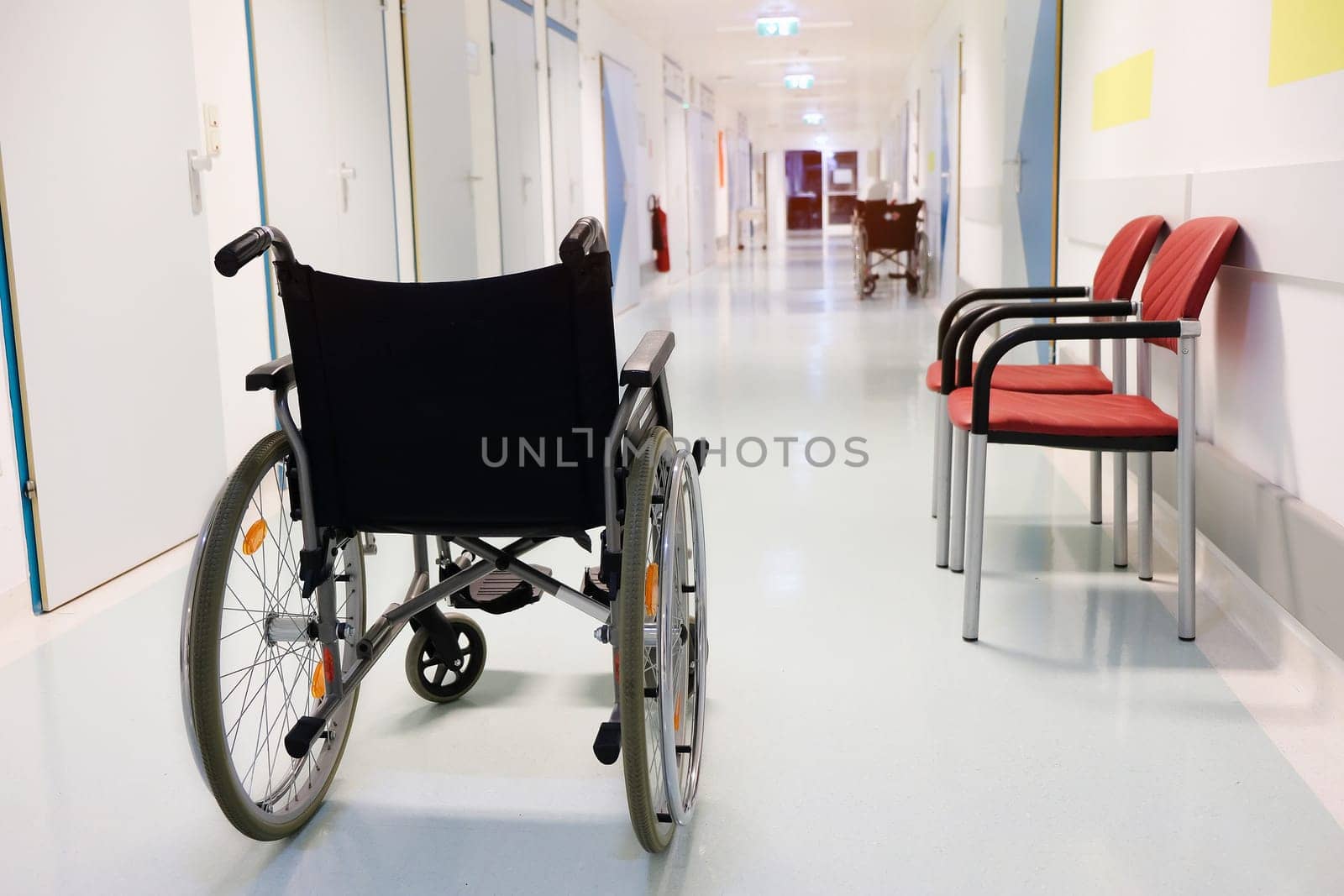 Wheel chair in the hospital corridor. Healthcare concept.